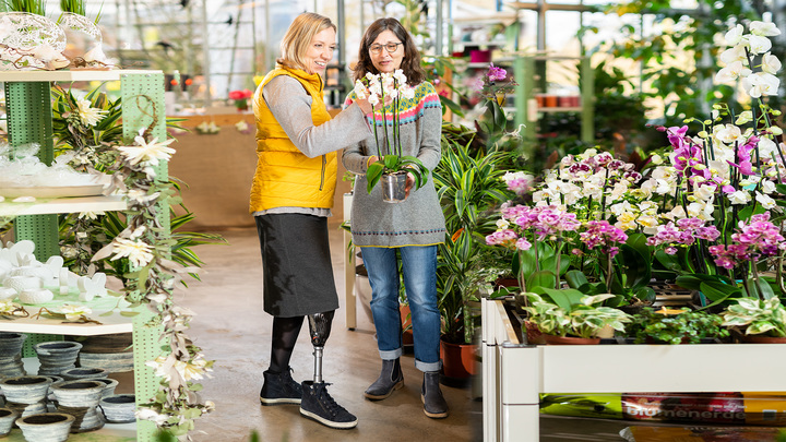 Anita wears her Trias prosthetic foot as she looks for plants for her garden at the garden centre.