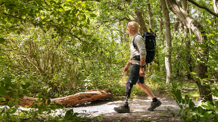 Flori hikes through the forest.