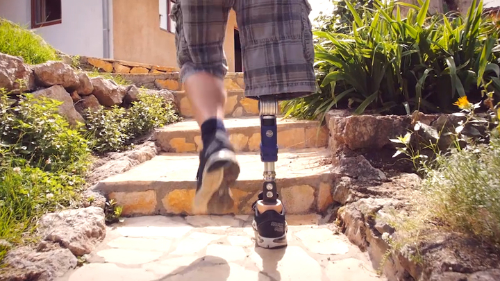 User walks up stairs in the garden