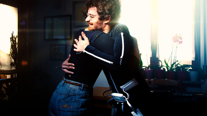 Exopulse Mollii Suit: Michele hugging his friend