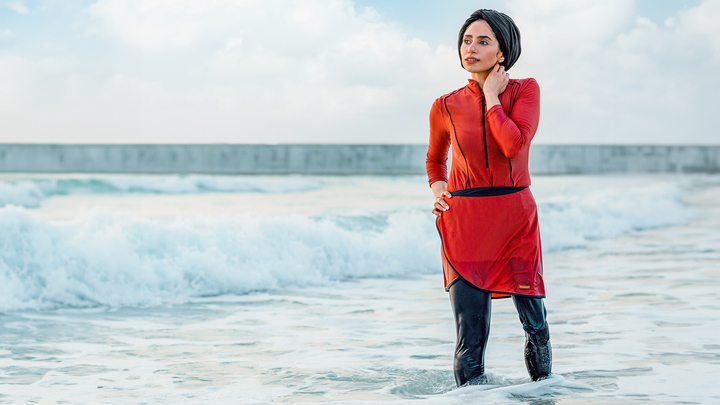 Genium X3 user Zainab walks in the ocean