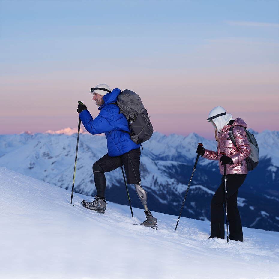 Genium X4 user Björn walking on a snow-covered mountain