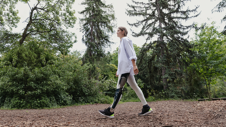 David wears his computer-controlled C-Brace® orthotronic mobility system as he strolls through the woods with his children.